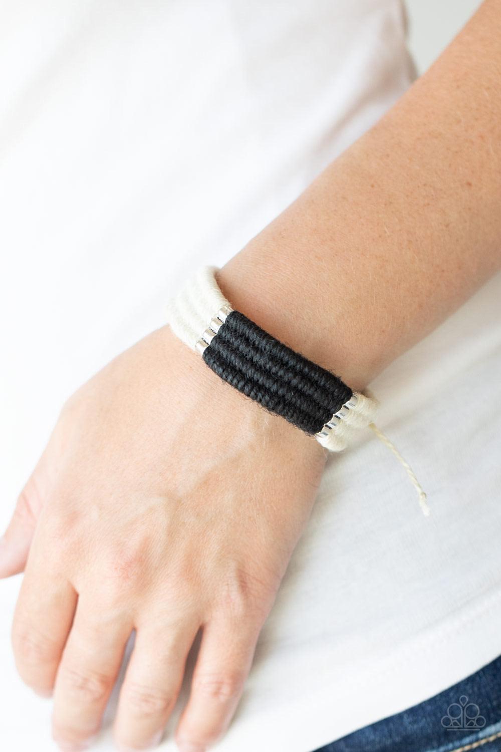 Paparazzi Accessories Hot Cross BUNGEE - Black Infused with metallic frames, rows of white and black twine-like cording knot into an earthy display around the wrist. Features an adjustable sliding knot closure. Sold as one individual bracelet. Bracelet