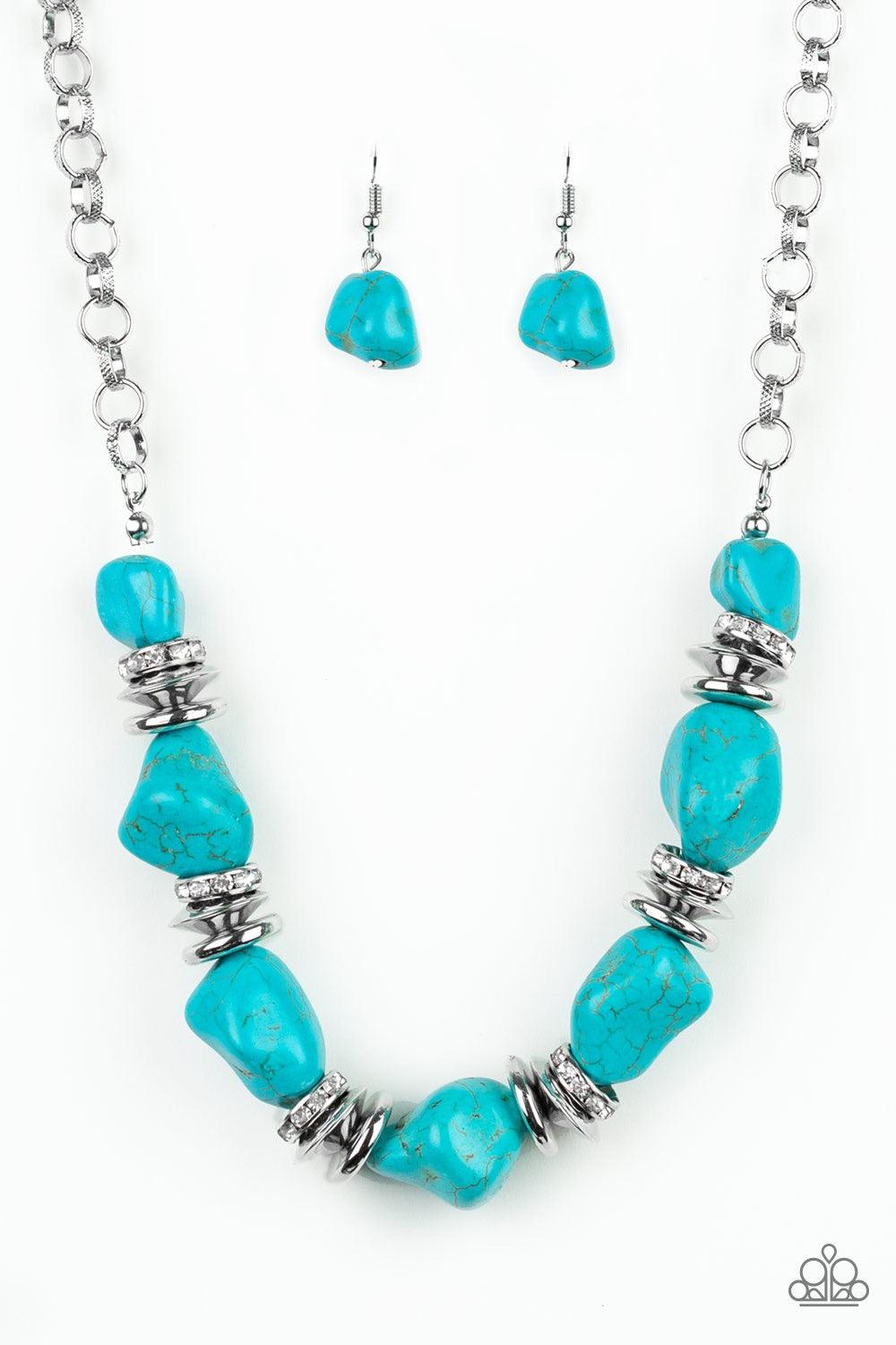 Paparazzi Accessories Stunningly Stone Age - Blue A collection of refreshing turquoise stones, shimmery silver accents, and white rhinestone encrusted rings are strung below the collar for a timeless look. Features an adjustable clasp closure. Jewelry
