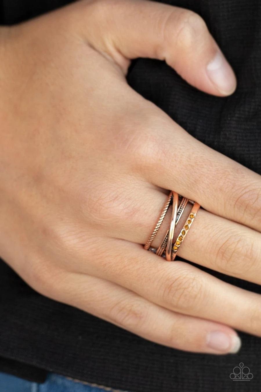 Paparazzi Accessories Stay in Your Lane - Copper Dotted with a dainty section of glittery topaz rhinestones, mismatched smooth and textured copper bars haphazardly layer across the finger for an edgy look. Features a stretchy band for a flexible fit. Sold