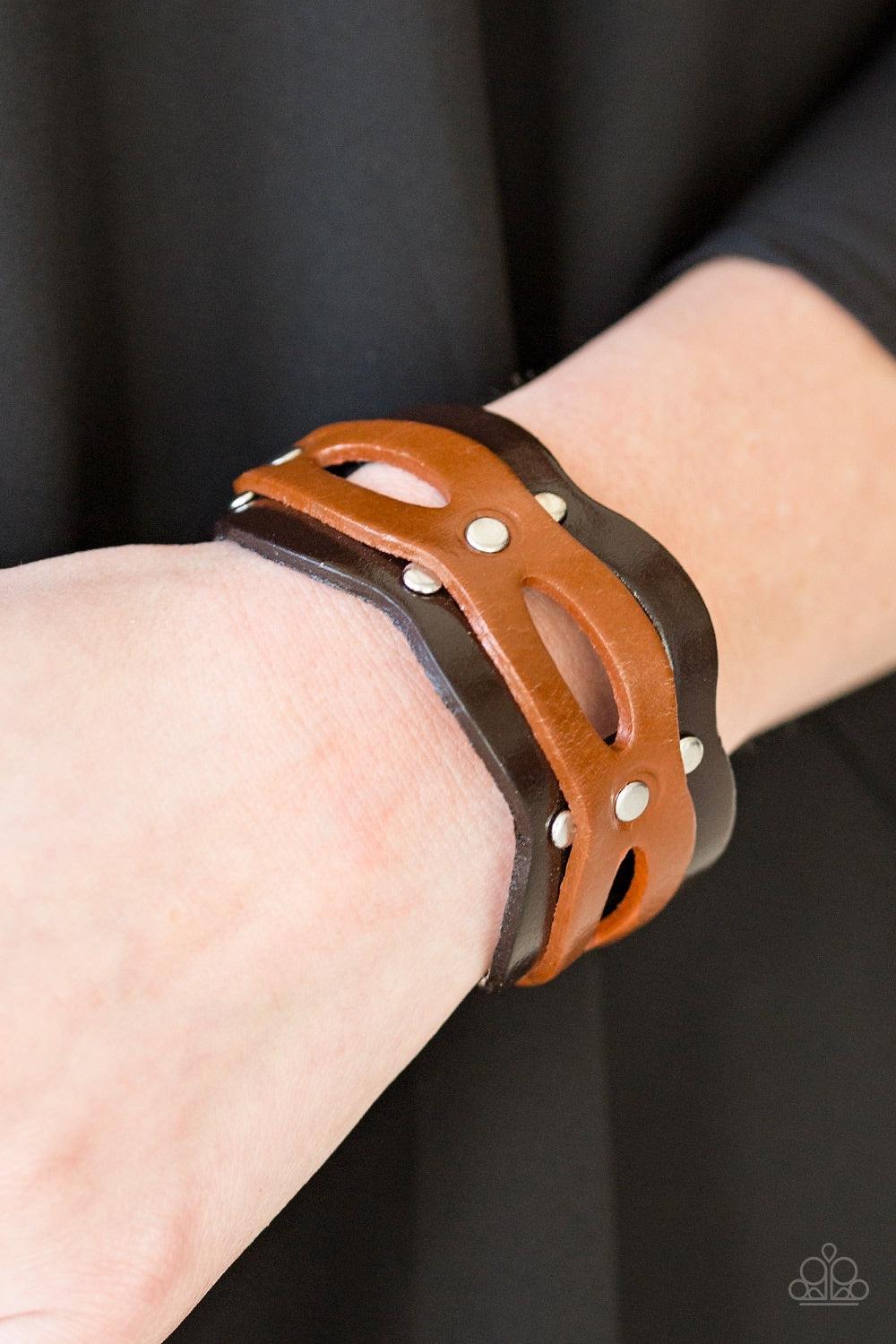 Paparazzi Accessories SPURS of The Moment - Brown Brushed in a shiny finish, an airy strip of light brown leather is studded across the front of a scalloped brown leather band for a rugged look. Features an adjustable snap closure. Jewelry