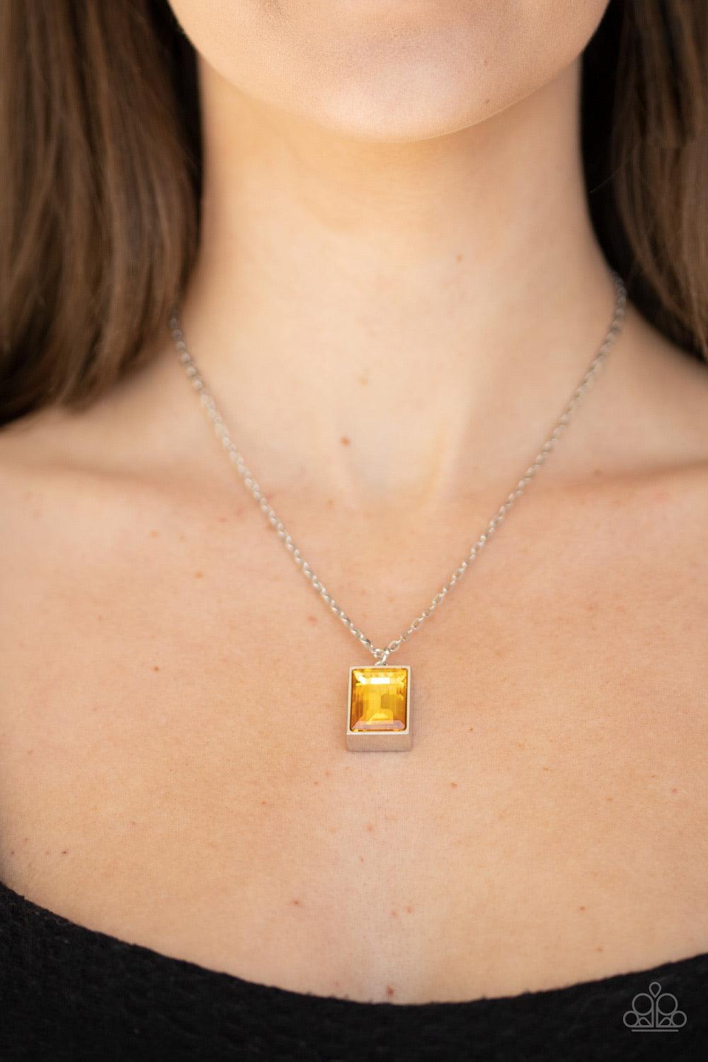 Paparazzi Accessories Pro Edge - Yellow Featuring an emerald style cut, a faceted yellow gem is pressed into a sleek silver frame at the bottom of a dainty silver chain below the collar for an edgy look. Features an adjustable clasp closure. Sold as one i