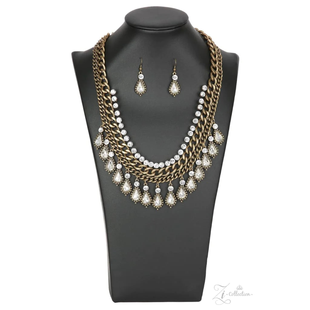 Paparazzi Accessories Revolution A row of dainty classic white rhinestones gives way to rows of thick brass chains. A fringe of sparkling rhinestone teardrops encased in textured frames dances along the bottom of the chains, adding uncompromising shimmer