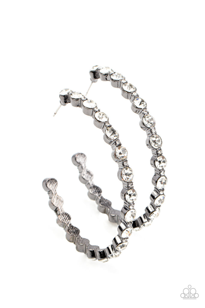 Paparazzi Accessories Royal Reveler - White Encased in silver fittings, a glamorous collection of glittery white rhinestones delicately coalesce into an oversized hoop for a sparkly statement. Earring attaches to a standard post fitting. Hoop measures app