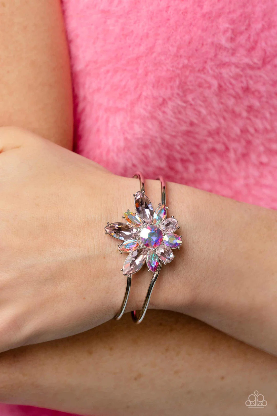 Paparazzi Accessories Chic Corsage - Pink Varying sizes of oval and marquise-cut gems in shades of light pink and shimmery iridescent bloom around a round-brilliant cut center in a similar iridescent hue. The dazzling collection of sparkly petals coalesce