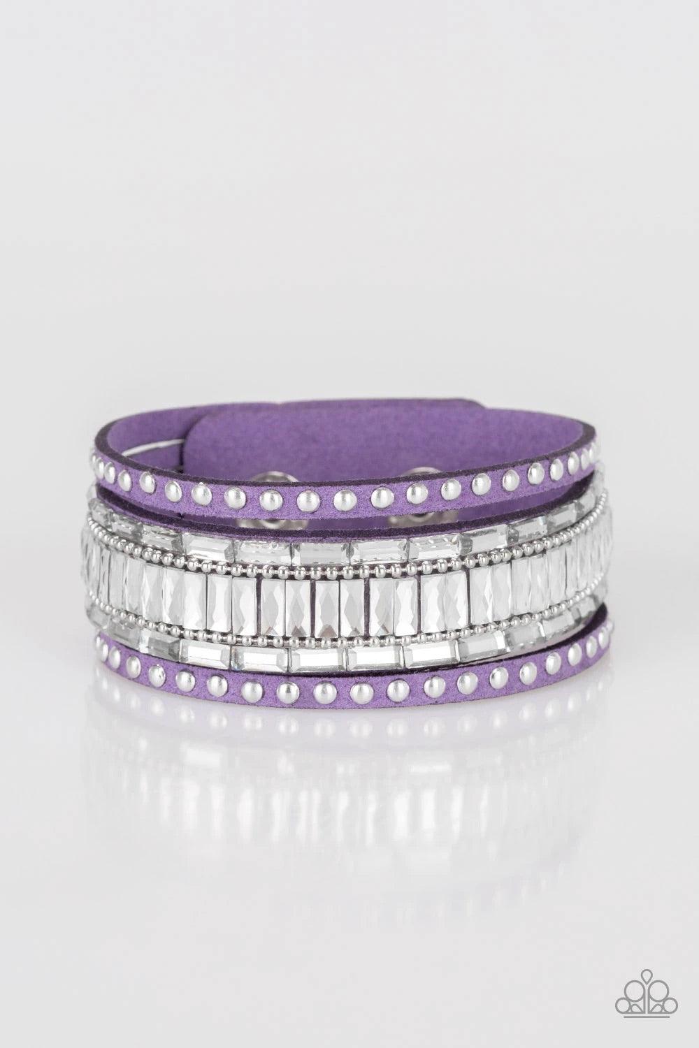 Paparazzi Accessories Rock Star Rocker - Purple Shiny silver studs, dainty silver ball chains, and edgy white emerald-cut rhinestones race along a spliced purple suede band for a rock star look. Features an adjustable snap closure. Sold as one individual