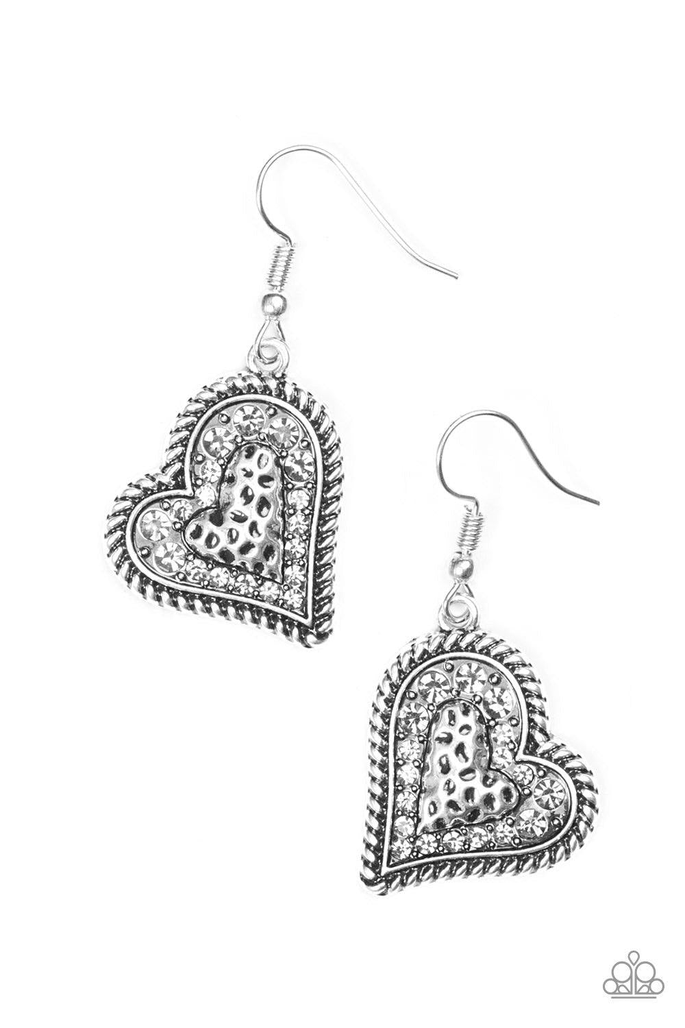 Paparazzi Accessories True Love - Silver Encrusted in smoky rhinestones, the center of a heart shaped frame is embossed in a textured heart for a flirty finish. Earring attaches to a standard fishhook fitting. Jewelry