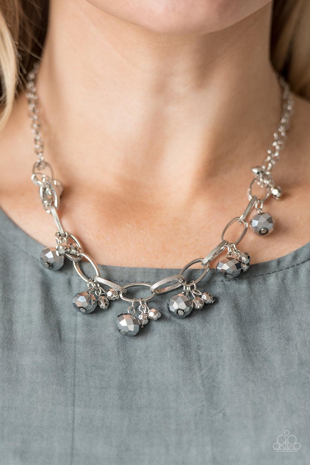Paparazzi Accessories Let’s Get This FASHION Show On The Road - Silver Featuring a metallic shimmer, faceted hematite beads swing from the bottom of bold silver links. Clusters of faceted silver beads join the metallic gems, creating a dramatic fringe bel