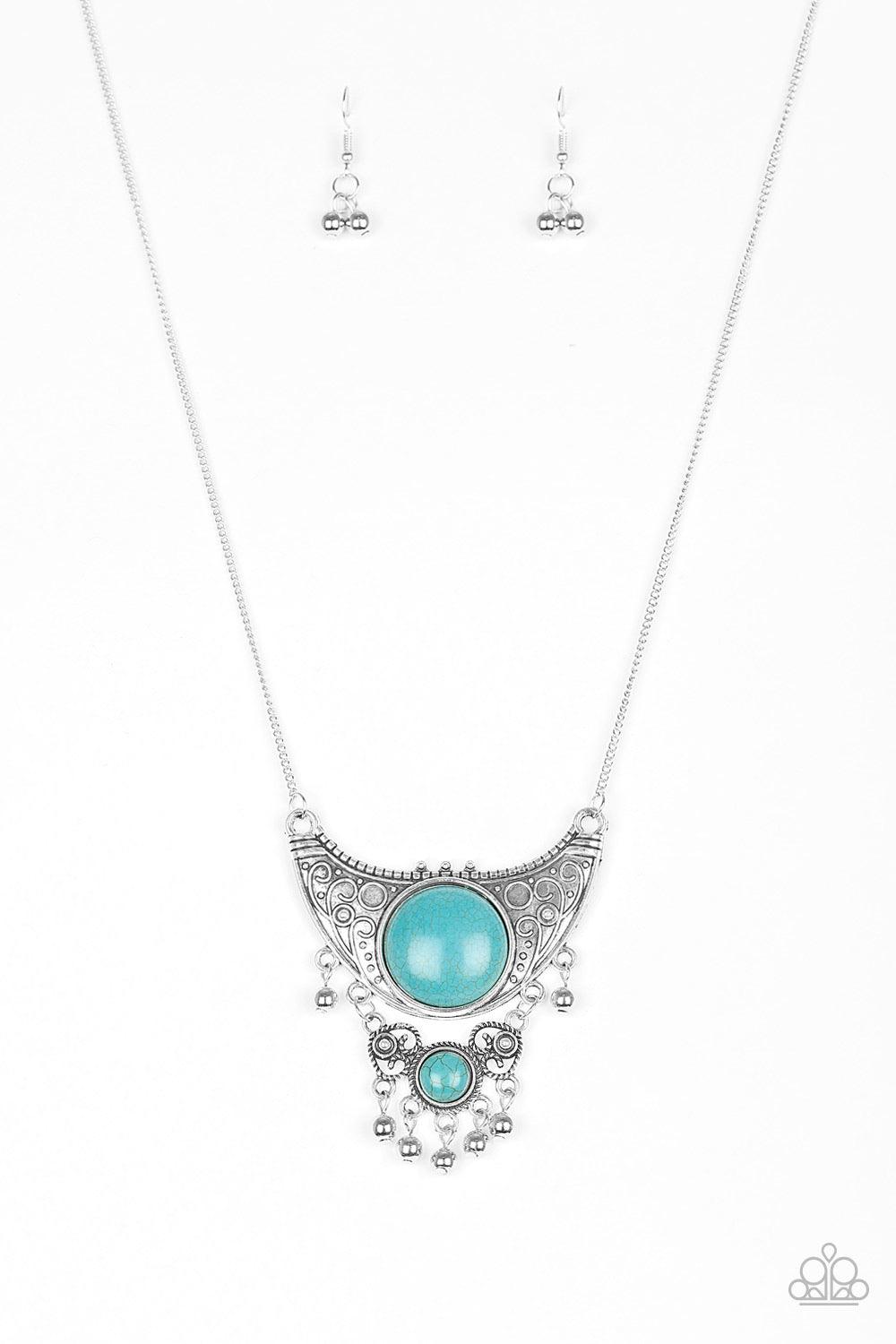Paparazzi Accessories Summit Style - Blue Embossed in dotted and swirling details, a large silver crescent attaches to a smaller frilly frame, creating a stacked pendant. Swinging from the bottom of a lengthened silver chain, the tribal inspired pendant f