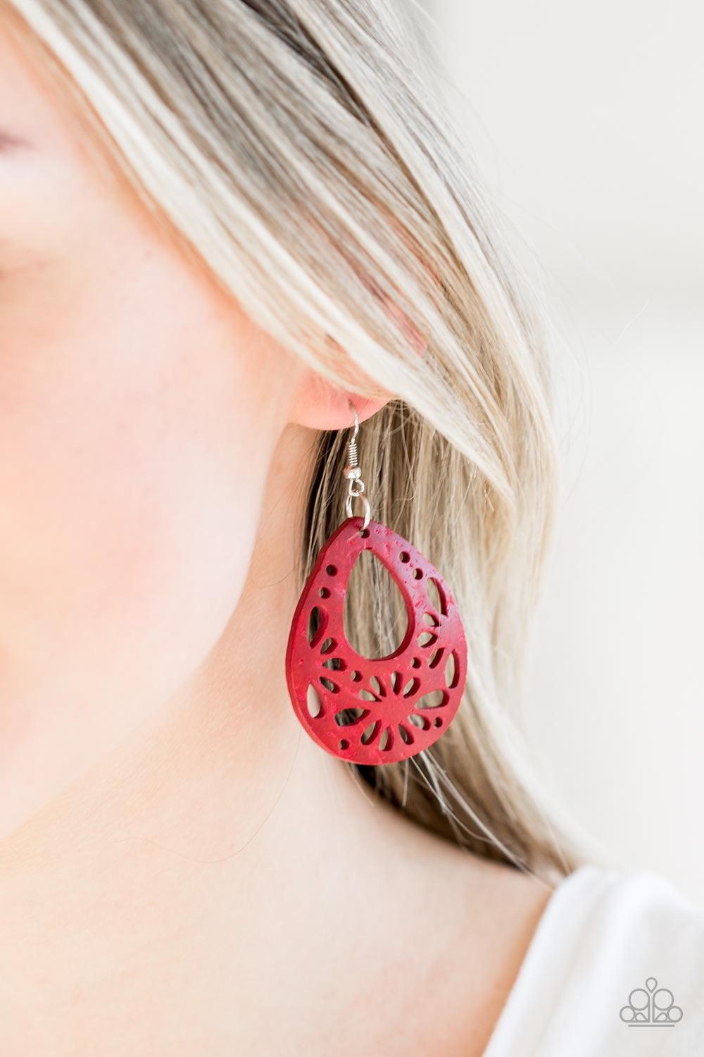 Paparazzi Accessories Merrily Marooned - Red Brushed in a colorful red finish, a wooden frame featuring airy stenciled patterns swings from the ear for a summery look. Earring attaches to a standard fishhook fitting. Jewelry