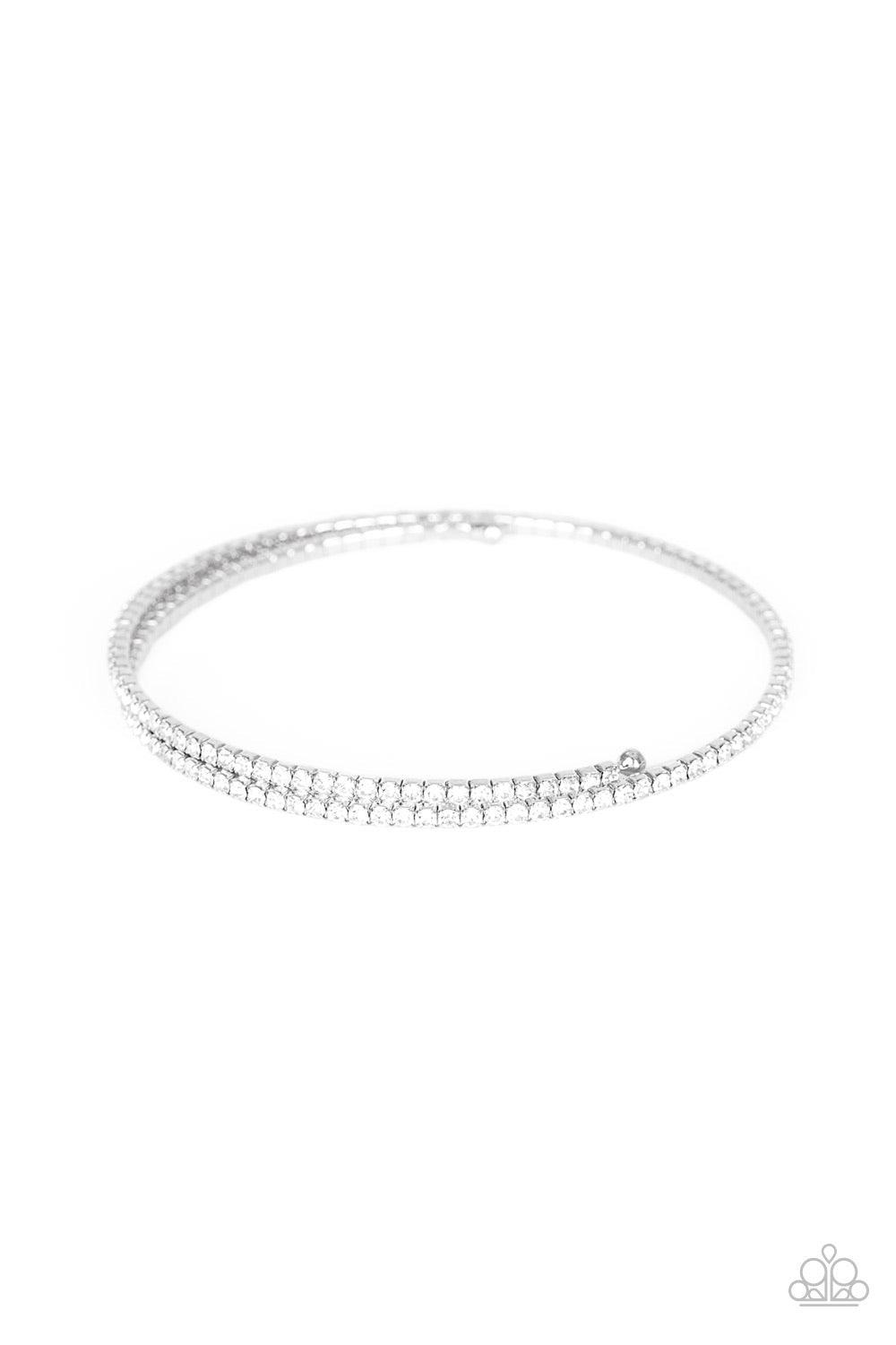 Paparazzi Accessories Sleek Sparkle - White Dotted in dainty white rhinestones, a flexible wire coils around the wrist for a refined flair. Jewelry
