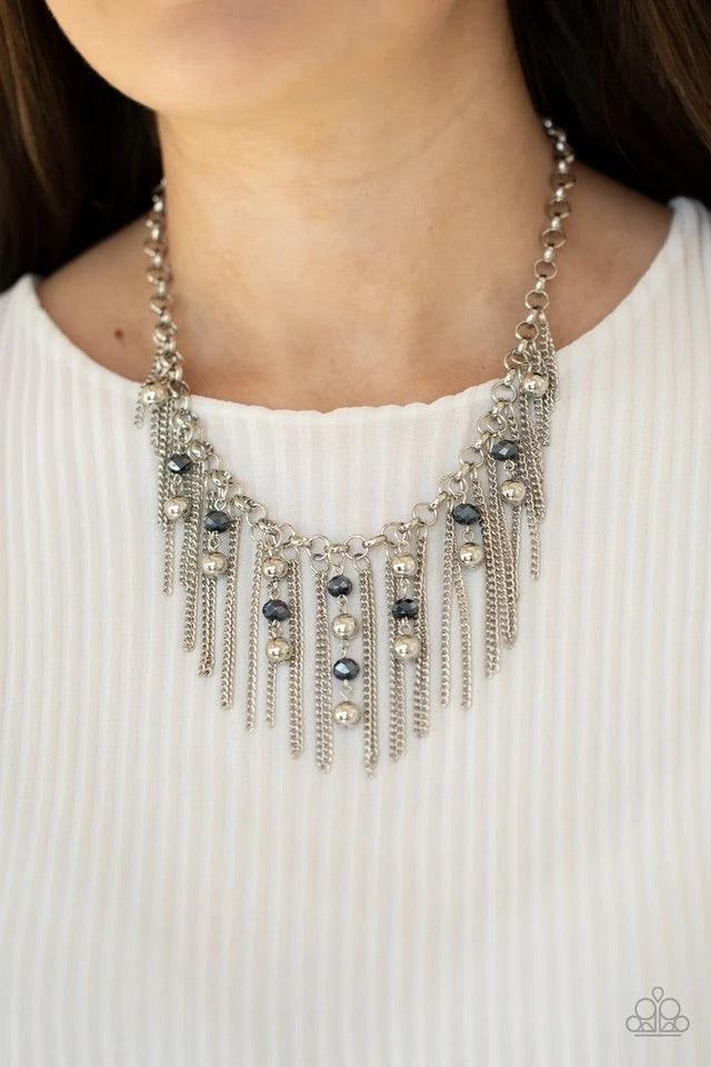 Paparazzi Accessories Ever Rebellious - Blue Glistening silver chains and strands of metallic blue crystal-like beads and glistening silver beads stream from the bottom of a bold silver chain, creating a sassy fringe below the collar. Features an adjustab