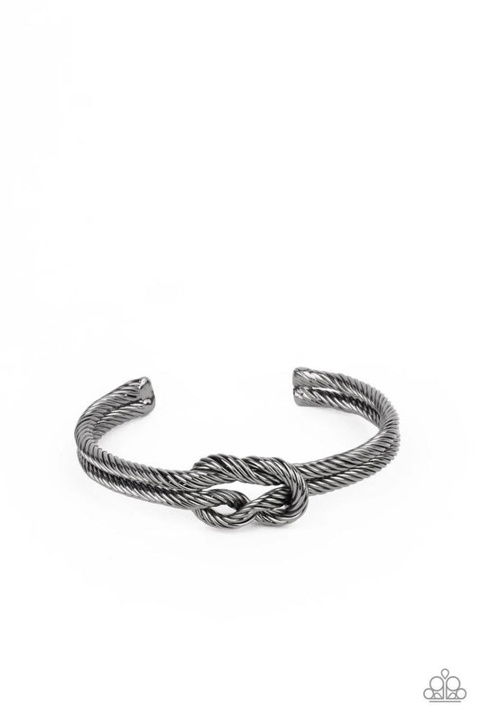 Paparazzi Accessories Nautical Grunge - Black Gritty gunmetal cable-like bars curl around the wrist, knotting into an edgy cuff for a bold industrial look. Sold as one individual bracelet. Jewelry