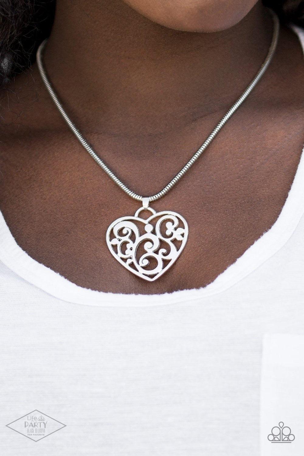 Paparazzi Accessories FILIGREE Your Heart With Love - Silver An airy heart swings from the bottom of shimmery silver cocoon chain, creating a whimsical pendant below the collar. Brushed in an antiqued shimmer, frilly filigree climbs the heart frame for a