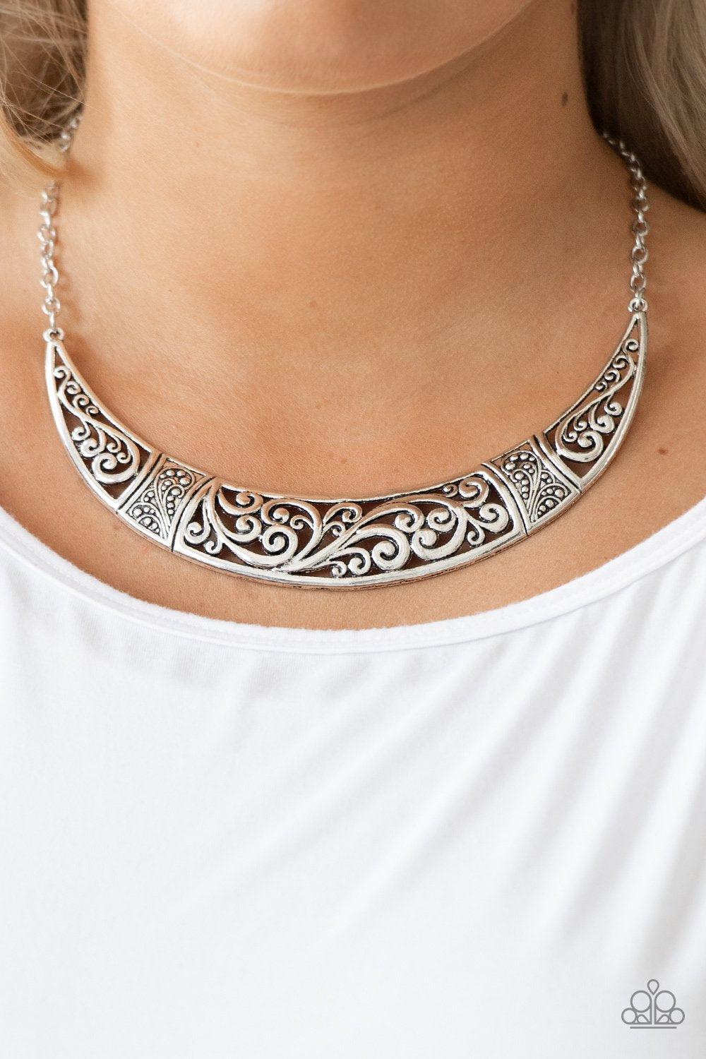 Paparazzi Accessories Bull In A China Shop - Silver Swirling with ornate filigree filled detail, a shimmery silver crescent plate swings below the collar for a fierce look. Features an adjustable clasp closure. Sold as one individual necklace. Includes on