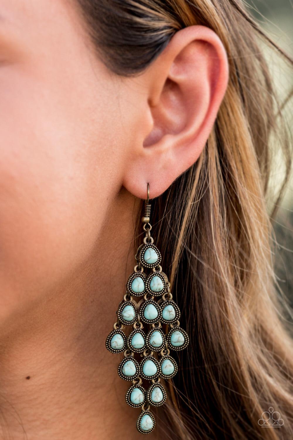 Paparazzi Accessories Rural Rainstorms - Brass Featuring studded brass frames, dainty turquoise teardrops cascade from the ear. The earthy frames dangle from a netted backdrop, coalescing into a rustic lure. Earring attaches to a standard fishhook fitting