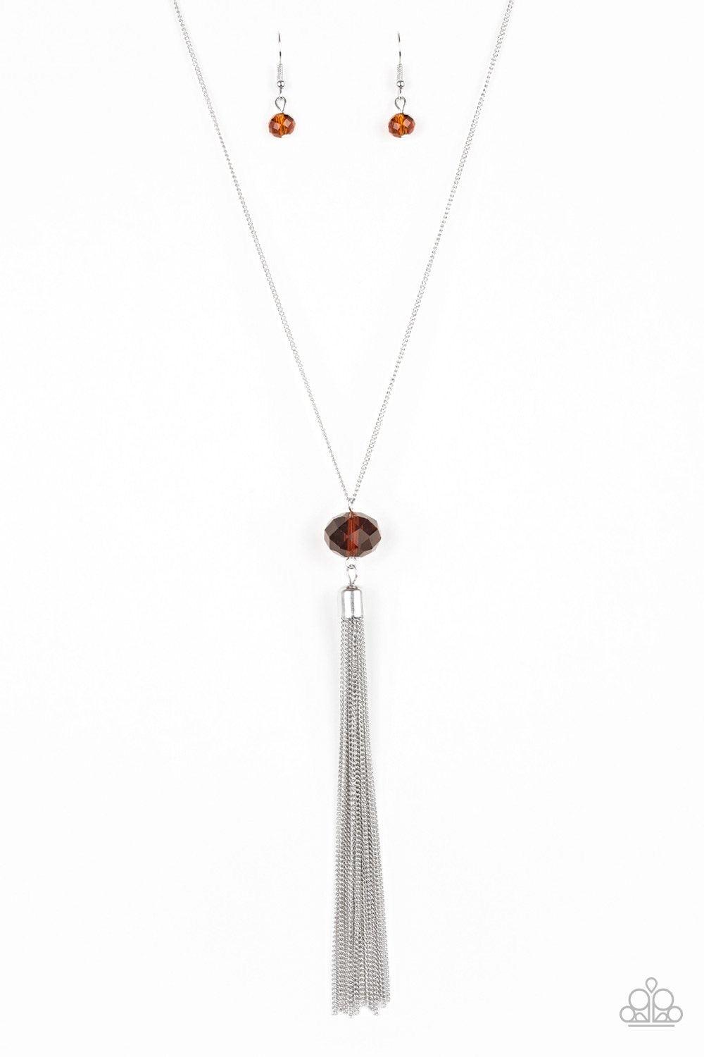 Paparazzi Accessories Socialite of the Season - Brown A glittery brown crystal-like bead swings from the bottom of a lengthened silver chain, giving way to a shimmering silver tassel for a glamorous finish. Features an adjustable clasp closure. Sold as on