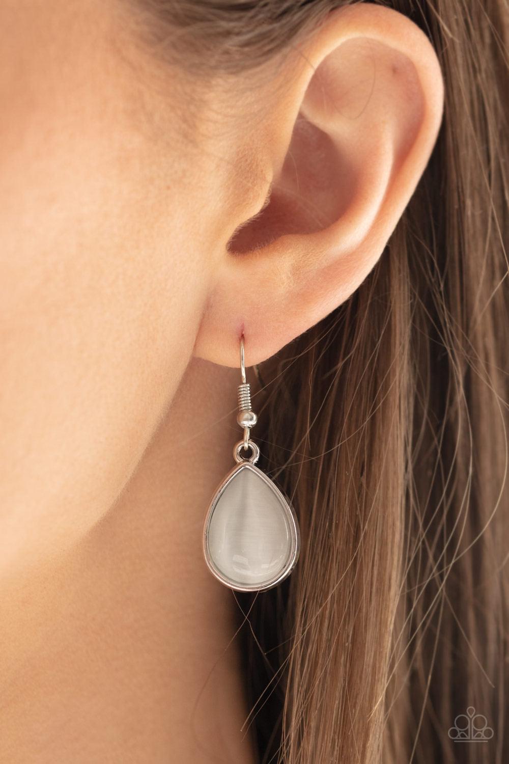 Paparazzi Accessories Dewy Decadence - White A series of white cat's eye teardrops interlock at the bottom of a silver chain, giving way to an oversized teardrop pendant for a refined finish. Features an adjustable clasp closure. Jewelry