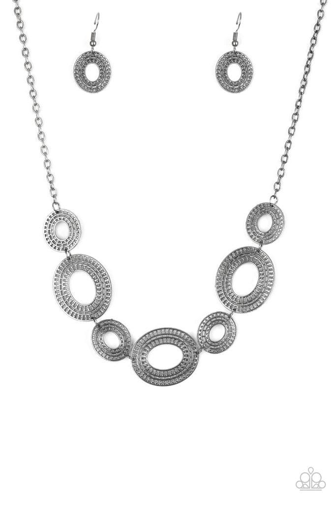 Paparazzi Accessories Basically Baltic - Black Radiating with circular details, airy oval frames link below the collar for a casual look. Features an adjustable clasp closure. Sold as one individual necklace. Includes one pair of matching earrings. Jewelr