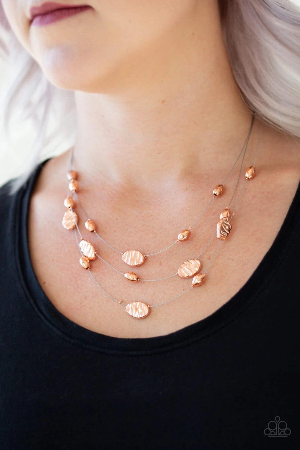 Paparazzi Accessories Top Zen - Copper Featuring smooth and delicately hammered finishes, mismatched shiny copper beads are threaded along dainty silver wire, creating floating layers below the collar. Features an adjustable clasp closure. Sold as one ind
