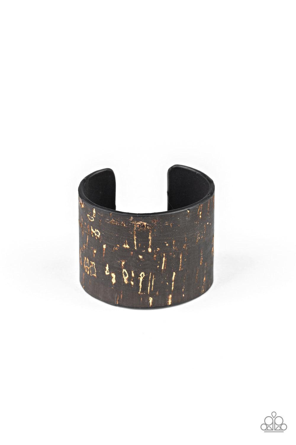 Paparazzi Accessories Up To Scratch - Black Featuring a black cork-like finish, a thick cuff is scratched, revealing lines of golden shimmer for a seasonal look. Jewelry