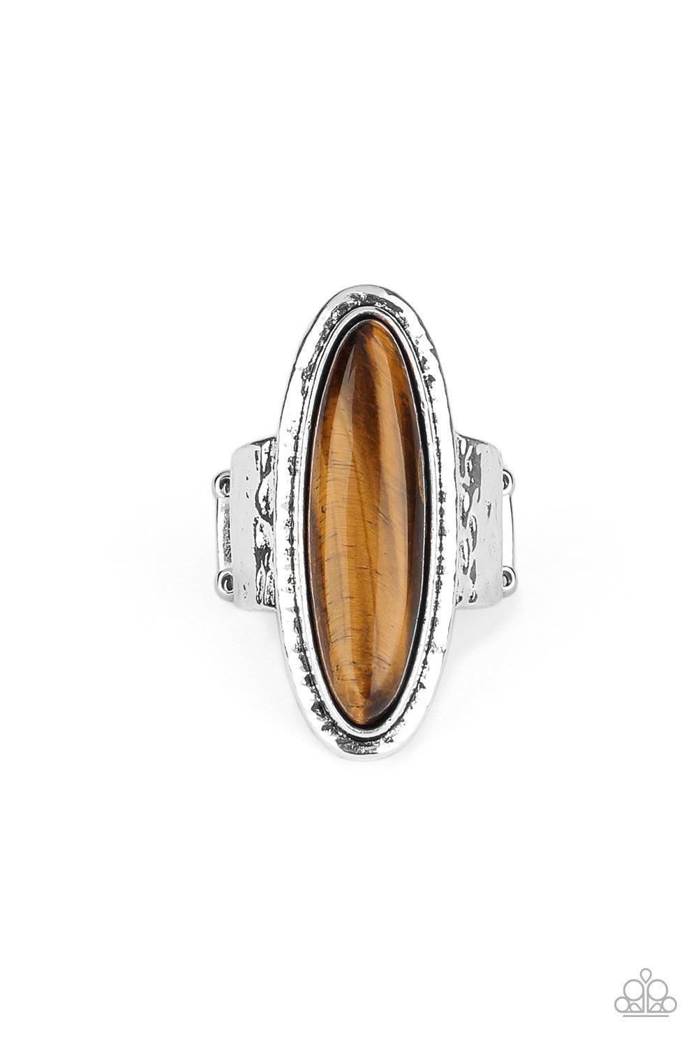 Paparazzi Accessories Stone Mystic - Brown An oblong Tiger’s Eye stone sits atop a hammered silver frame atop a hammered silver band, creating an earthy statement piece. Features a stretchy band for a flexible fit. Jewelry