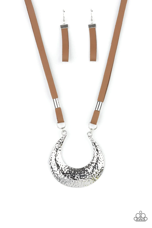 Paparazzi Accessories Majorly Moonstruck - Brown Infused with shiny silver beads, strips of brown leather link to an oversized half moon pendant that is hammered in a blinding silver finish, creating a rustic statement piece below the collar. Features an