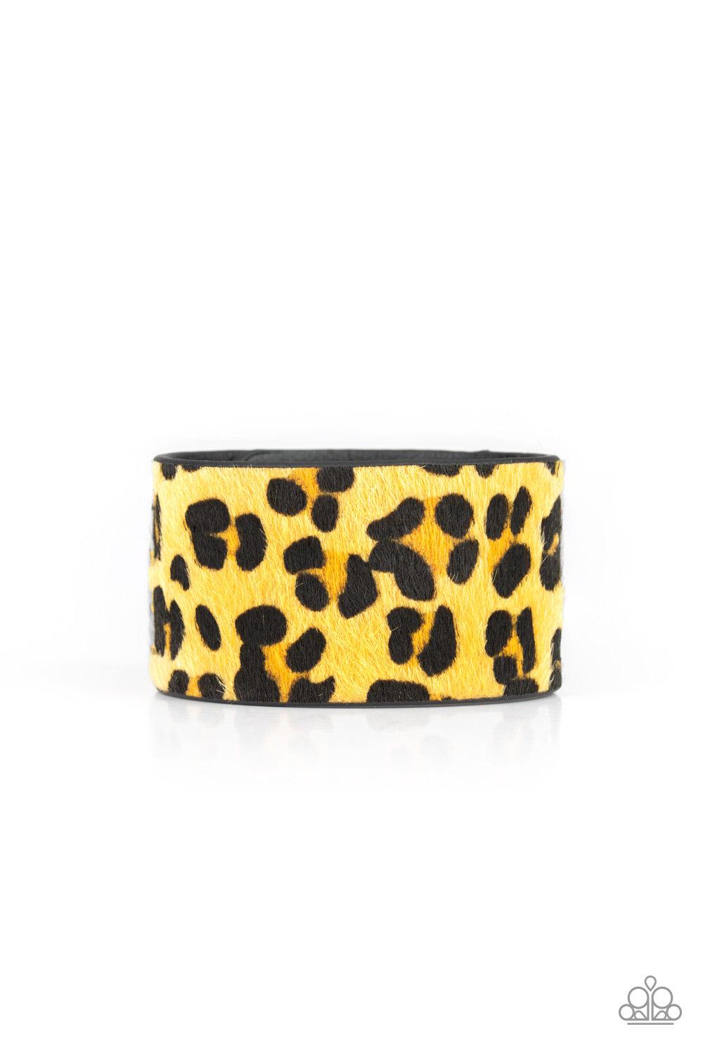 Paparazzi Accessories Cheetah Cabana - Yellow A fuzzy yellow cheetah pattern is printed across the front of a thick black leather band for a wild look. Features an adjustable snap closure. Jewelry