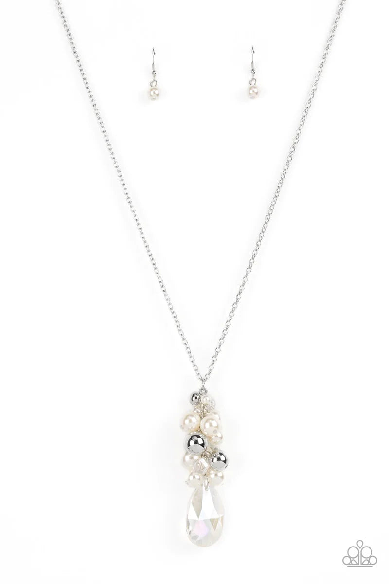Paparazzi Accessories Drip Drop Dazzle - White Featuring an iridescent shimmer, a dramatically oversized crystal-like teardrop swings from the bottom of a cluster of shiny silver, pearly white, and crystal-like beads, creating a dazzling pendant at the bo
