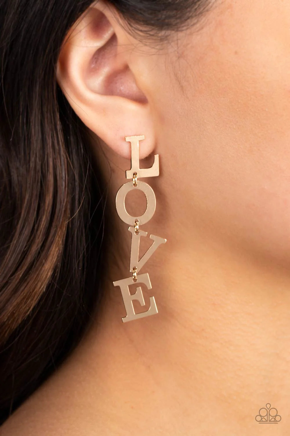 Paparazzi Accessories L-O-V-E - Gold Gold letters with a lightly hammered sheen spell out the word "LOVE" as they vertically cascade down the ear in a flattering finish. Each of the letters are interconnected to one another giving the piece some whimsical