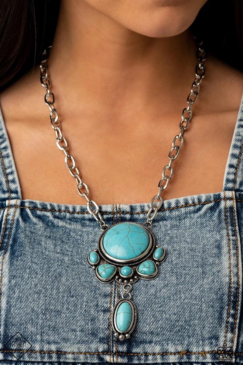 Paparazzi Accessories Geographically Gorgeous - Blue A large turquoise stone encased in a studded silver frame is swings dramatically from a heavy silver chain with oversized links. A collection of turquoise stones wraps around the bottom of the large pen