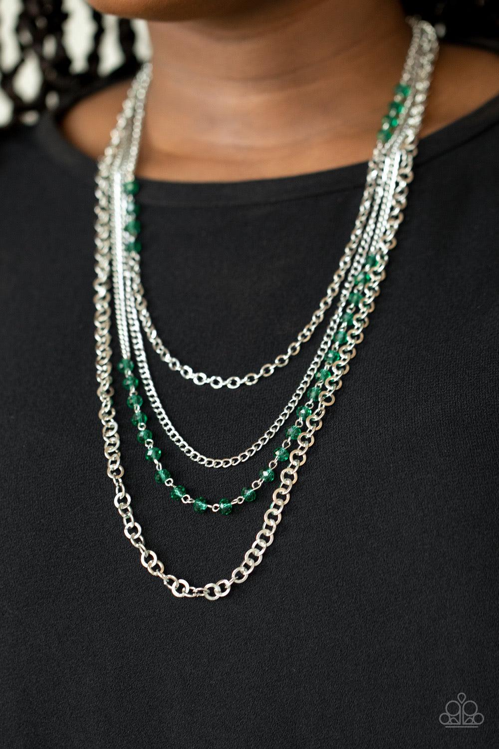 Paparazzi Accessories Flickering Lights - Green Featuring sections of glittery green crystal-like beads, a collision of mismatched silver chains drapes down the chest, creating flickering layers. Features an adjustable clasp closure. Sold as one individua
