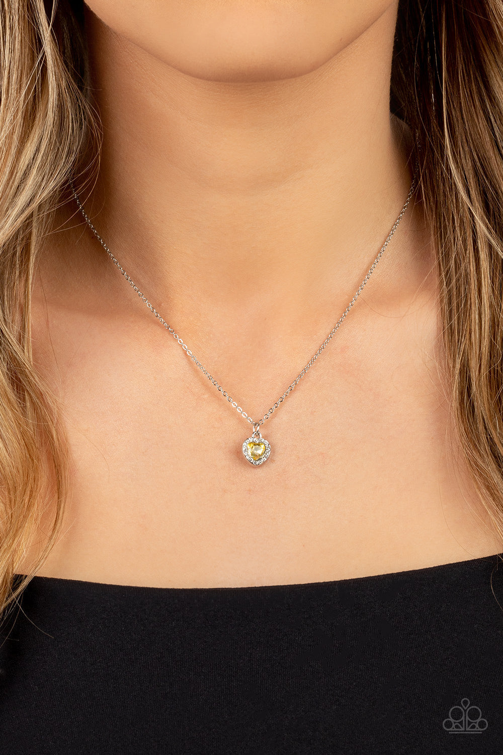 Paparazzi Accessories A Little Lovestruck - Yellow Bordered in glassy white rhinestones, a dainty yellow rhinestone heart sparkles along a dainty silver chain below the collar for a flirtatious fashion. Features an adjustable clasp closure. Sold as one in