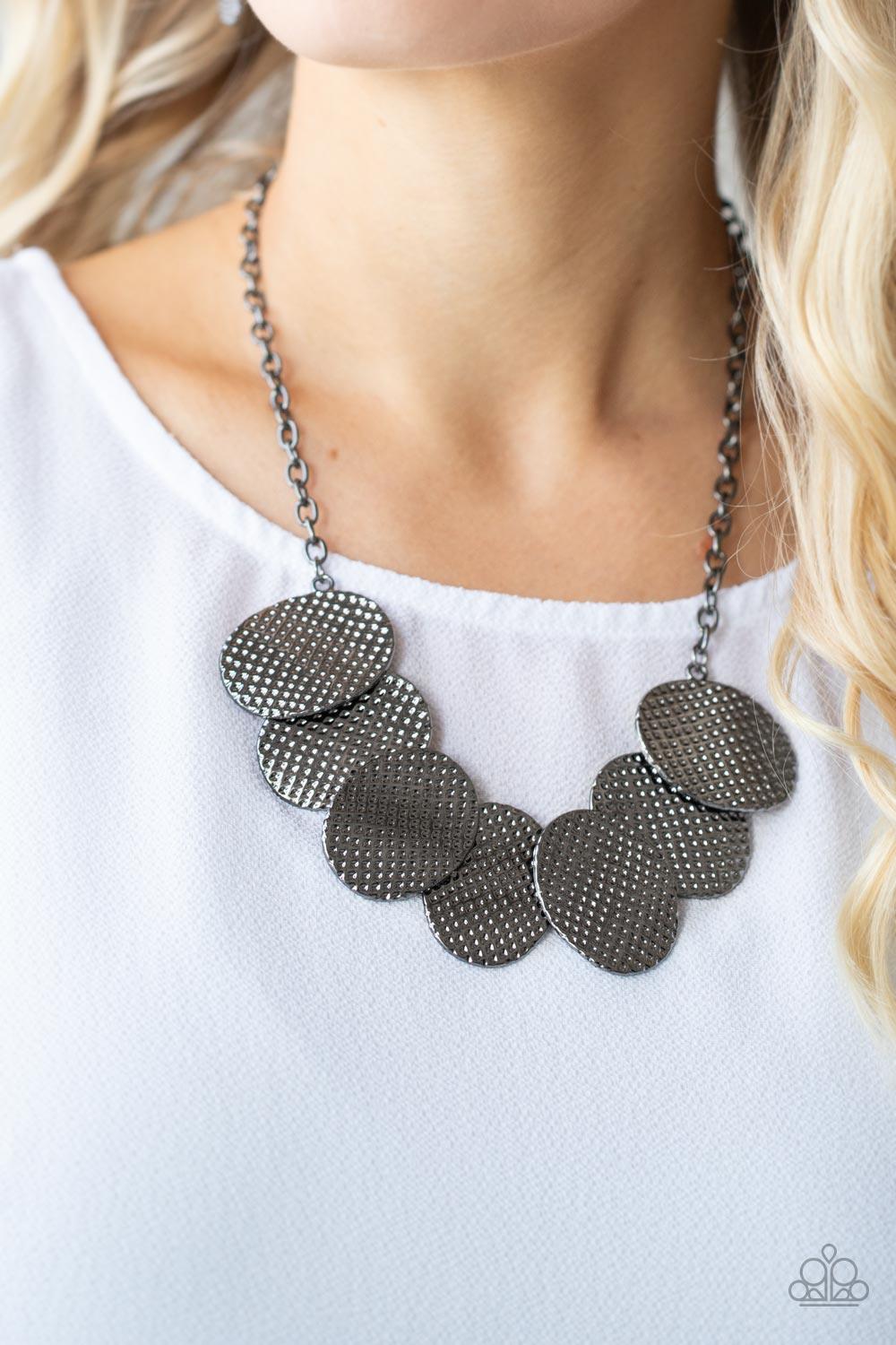 Paparazzi Accessories Industrial Wave - Black A row of gently warped gunmetal discs link together in an overlapping fashion as they connect on each end to a gunmetal chain. Etched in a hammered gunmetal finish, the oval discs create an edgy industrial eff