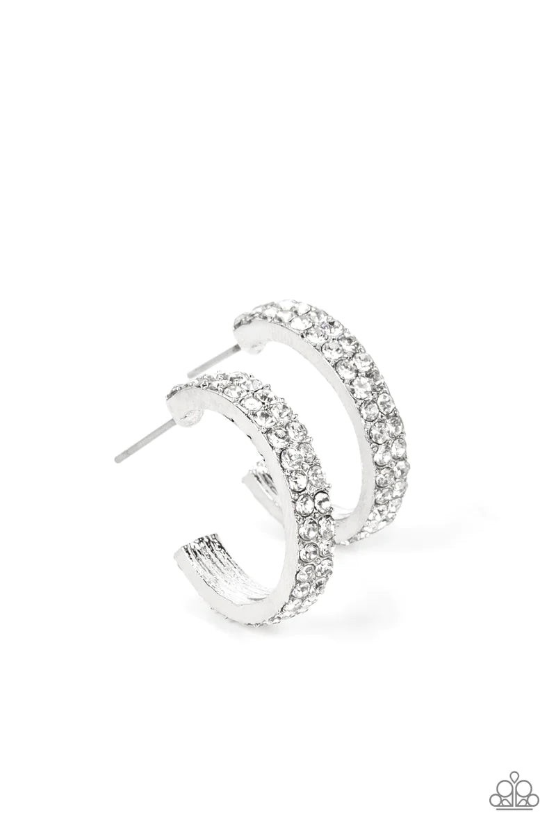 Paparazzi Accessories Positively Petite - White Sparkling white rhinestones line the front of a petite silver hoop, creating edge to edge shimmer. Earring attaches to a standard post fitting. Hoop measures approximately 3/4 in diameter. Sold as one pair o