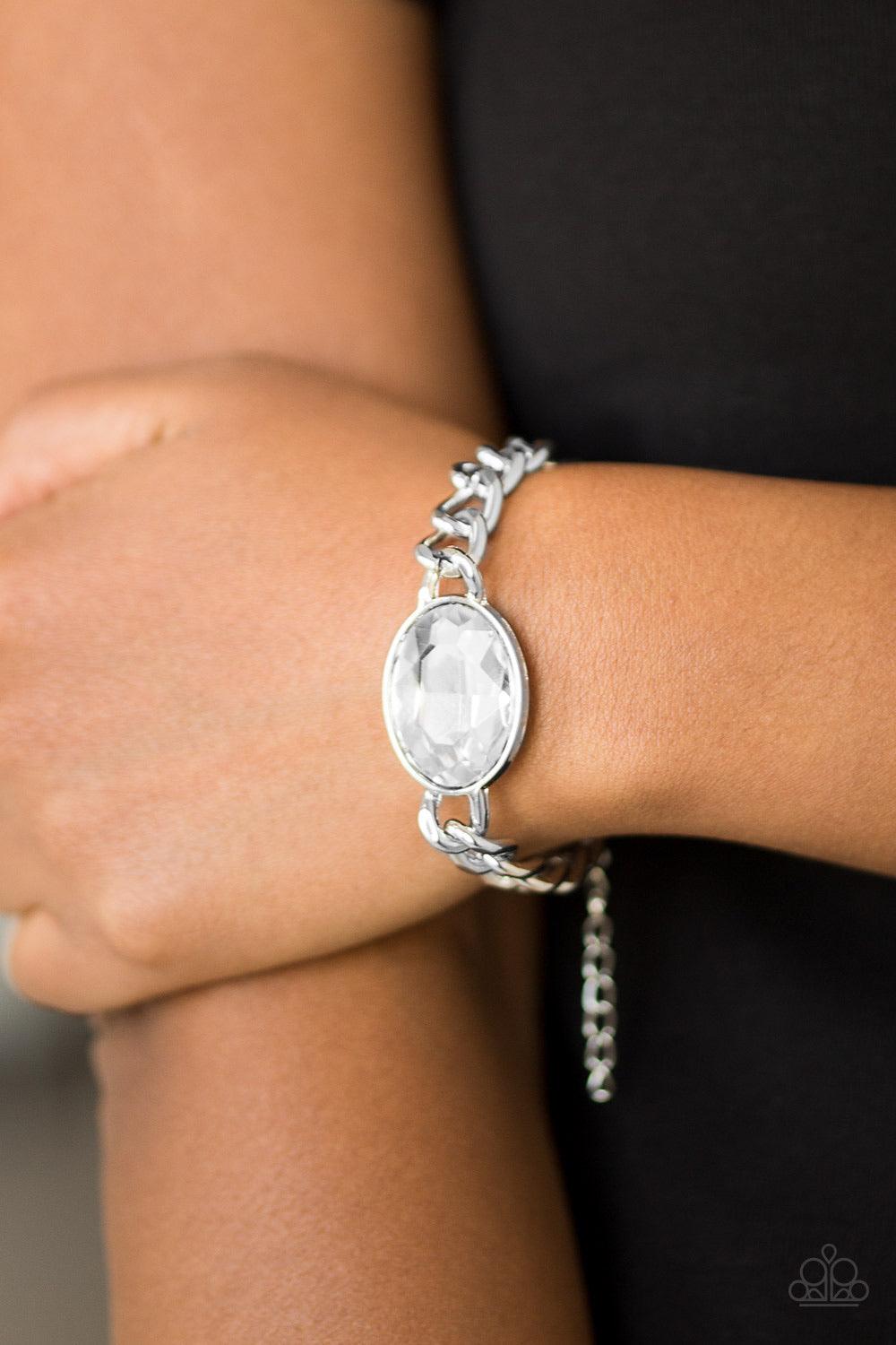 Paparazzi Accessories Luxury Lush - White An oversized white gem attaches to a bold silver chain, creating a dramatic centerpiece atop the wrist. Features an adjustable clasp closure. Jewelry