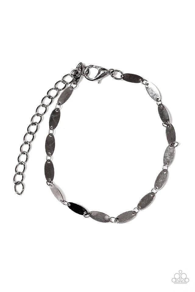 Paparazzi Accessories Flash Fire - Black Flat gunmetal frames link together around the wrist, creating a dainty chain. Brushed in a high-sheen finish, the flat gunmetal surfaces easily reflect the light creating a flashy palette from any angle. Features a