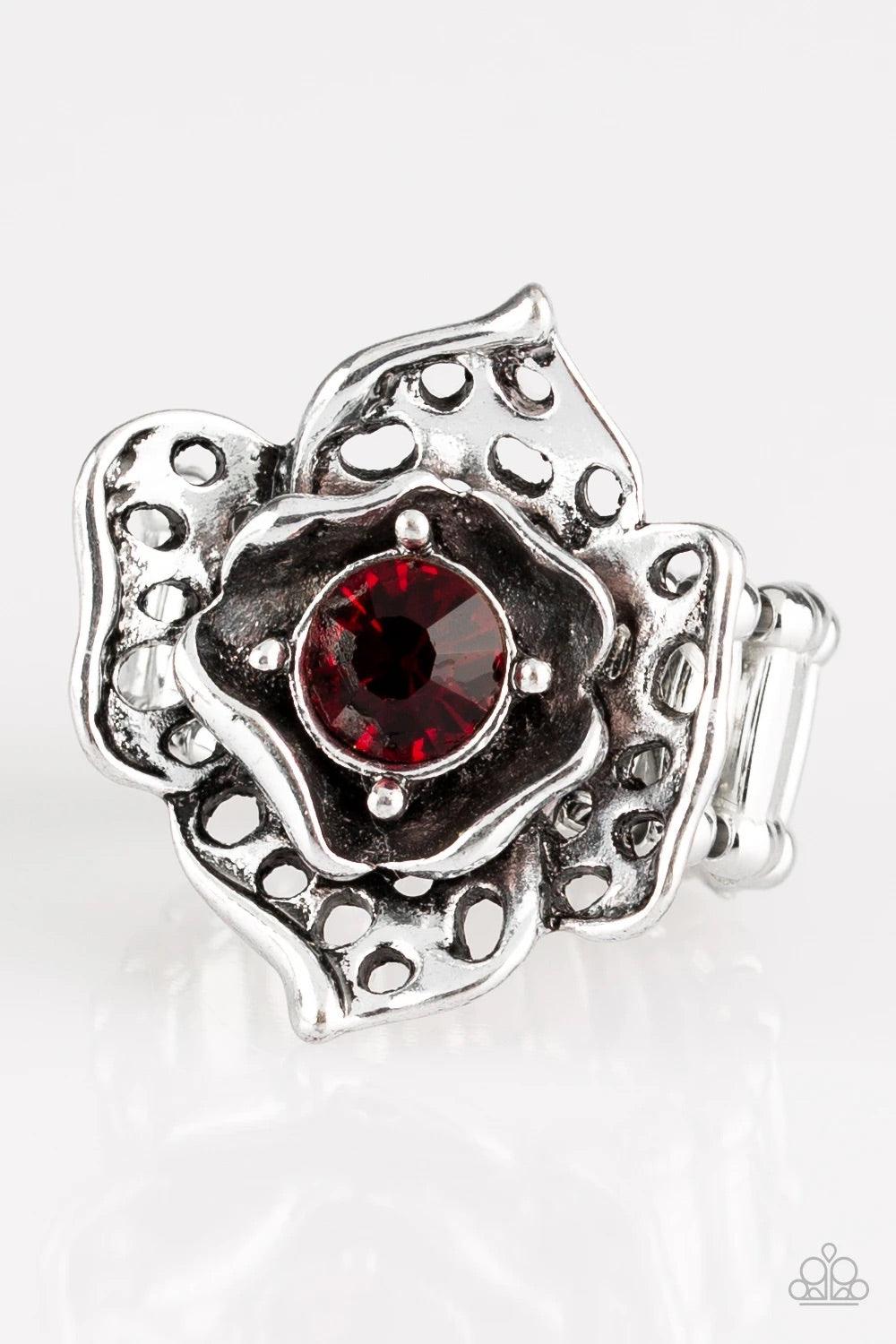 Paparazzi Accessories Glowing Gardens - Red Featuring airy cut-out textures, antiqued silver petals gather around a glowing red rhinestone center for a whimsical look. Features a stretchy band for a flexible fit. Sold as one individual ring. Jewelry