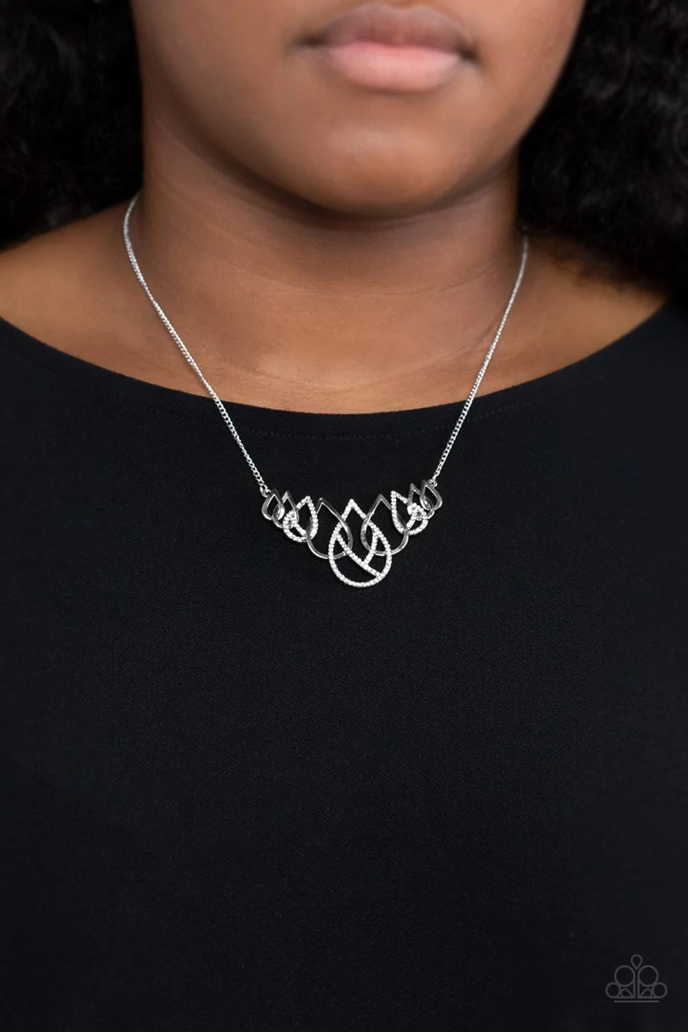 Paparazzi Accessories Thunderstruck Teardrops - White Gradually increasing in size, shiny silver and white rhinestone encrusted silver teardrops ornately interlock below the collar for a glamorous fashion. Features an adjustable clasp closure. Sold as one