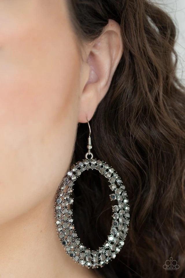 Paparazzi Accessories Radical Razzle - Silver Row after row of glittery hematite rhinestones encircle into an oversized hoop, creating a gritty glamorous look. Earring attaches to a standard fishhook fitting. Sold as one pair of earrings. Jewelry