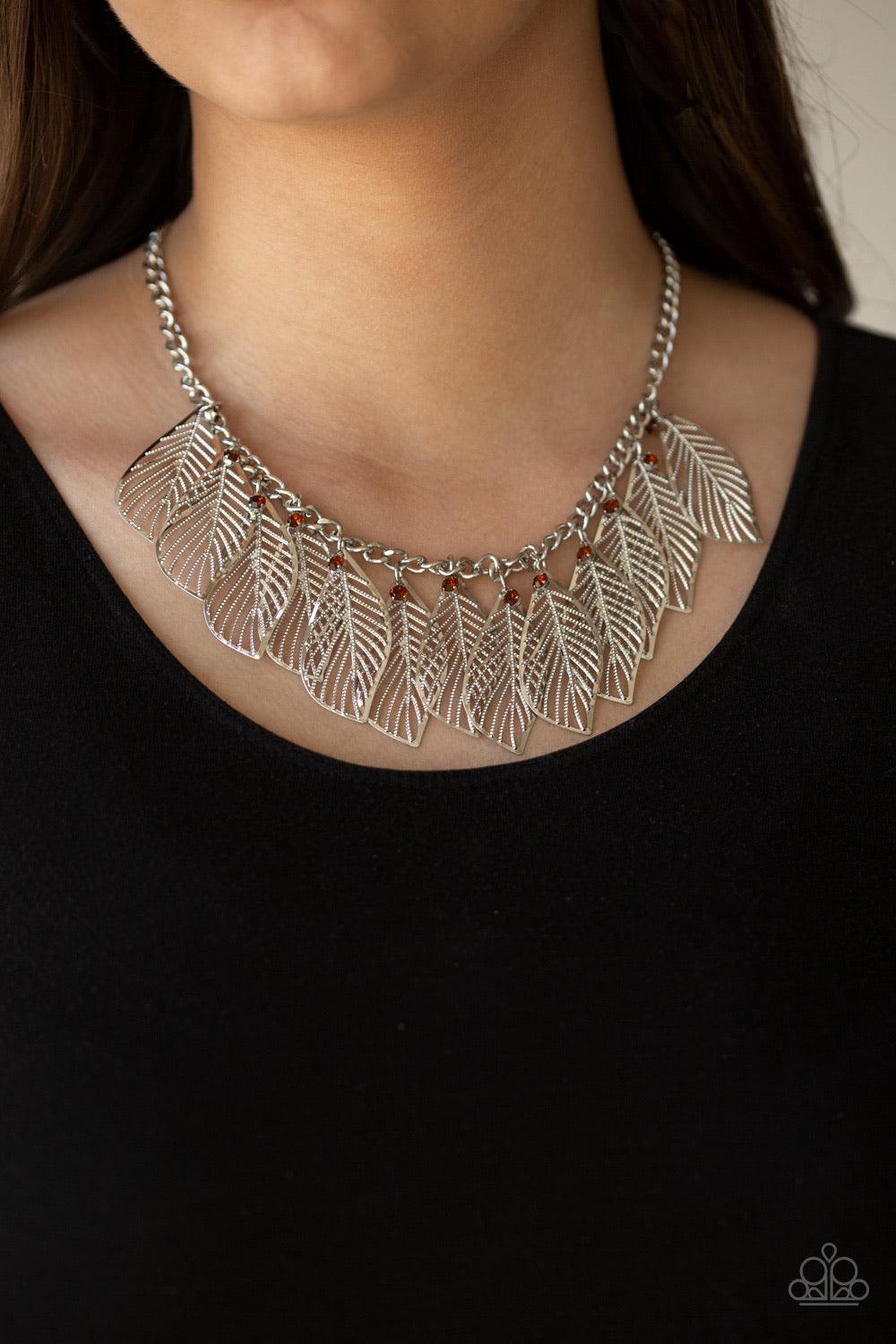 Paparazzi Accessories Feathery Foliage - Brown Dainty topaz rhinestones and leafy silver feathers swing from a thick silver chain, creating a whimsical fringe below the collar. Features an adjustable clasp closure. Jewelry