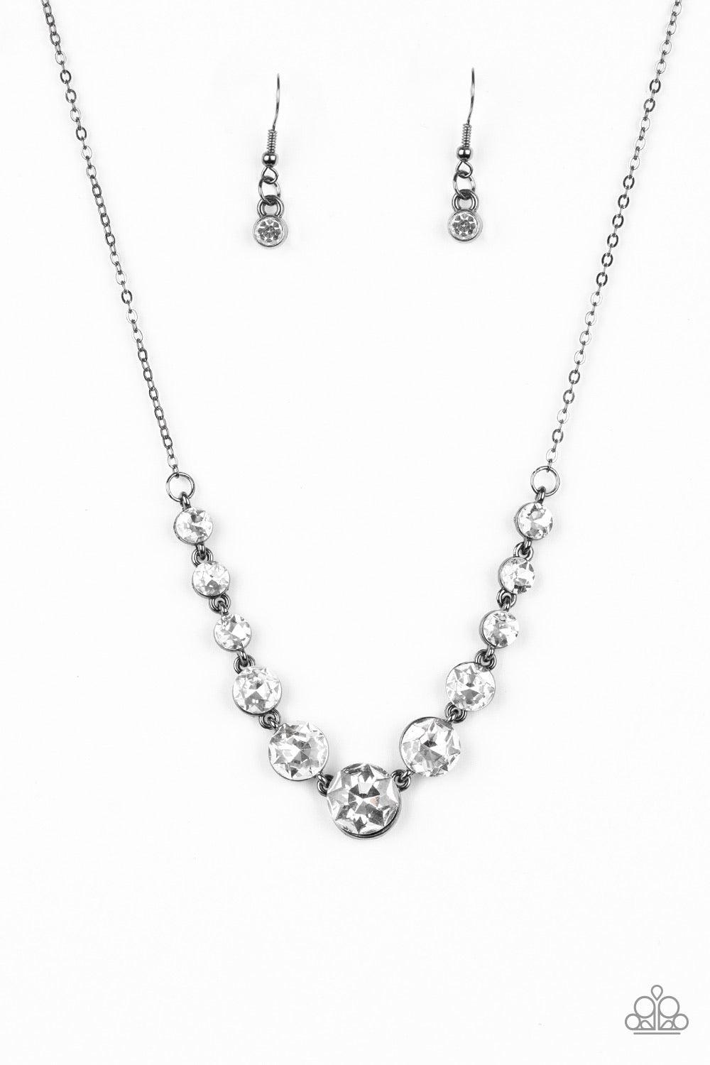 Paparazzi Accessories Leading Socialite - Black Gradually increasing in size near the center, a collection of glassy white rhinestones links below the collar for a timeless look. Features an adjustable clasp closure. Sold as one individual necklace. Inclu