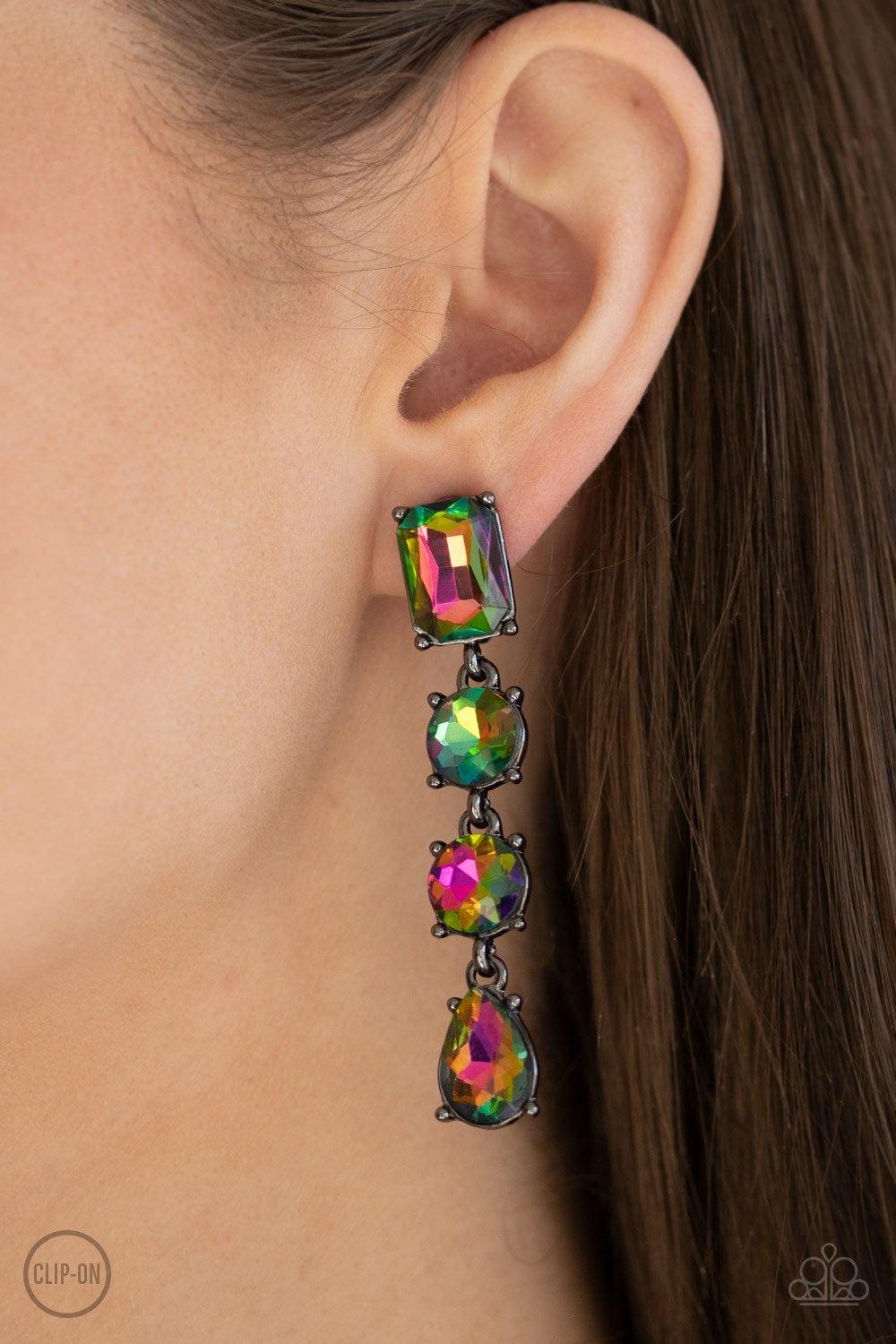 Paparazzi Accessories Make A-LIST - Multi *Clip-On Featuring a colorful oil spill finish, a collection of emerald, round, and teardrop cut rhinestones drip from the ear, connecting into a glamorous lure. Earring attaches to a standard clip-on fitting. Sol