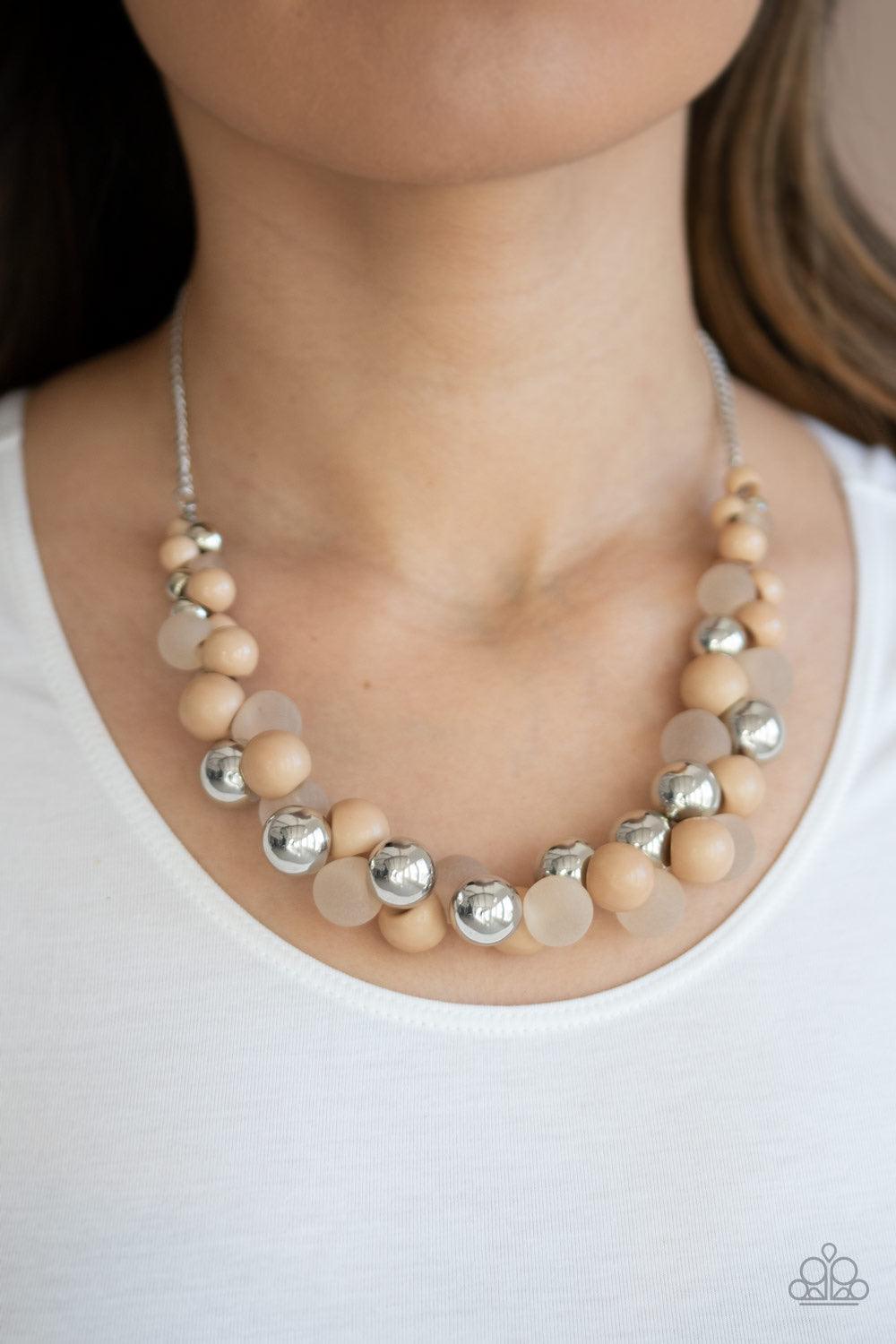 Paparazzi Accessories Bubbly Brilliance - Brown A bubbly collection of imperfect silver, opaque, and Lark beads are threaded along an invisible wire below the collar, creating a colorful cluster. Features an adjustable clasp closure. Jewelry
