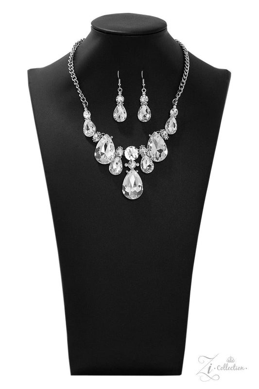 Paparazzi Accessories Reign Dramatic frames featuring tranquil teardrop and classic round white rhinestones delicately link below the collar for a showstopping look. A large teardrop rhinestone drips from the center, creating an unapologetic pendant that