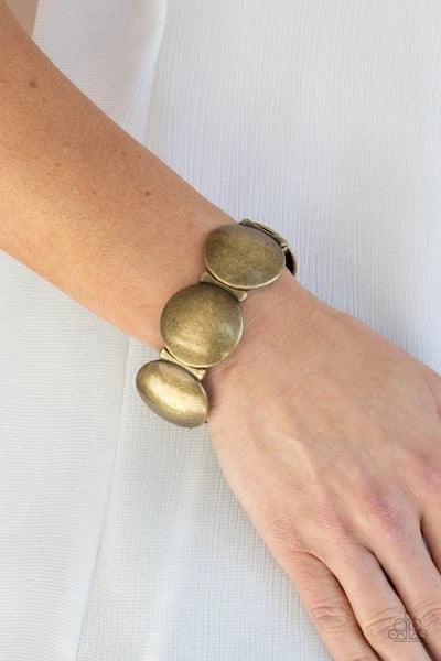 Paparazzi Accessories Going, Going, GONG! - Brass Infused with curved bar-like accents, an antiqued series of beveled brass discs are threaded along stretchy bands around the wrist for a bubbly metallic look. Sold as one individual bracelet. Jewelry