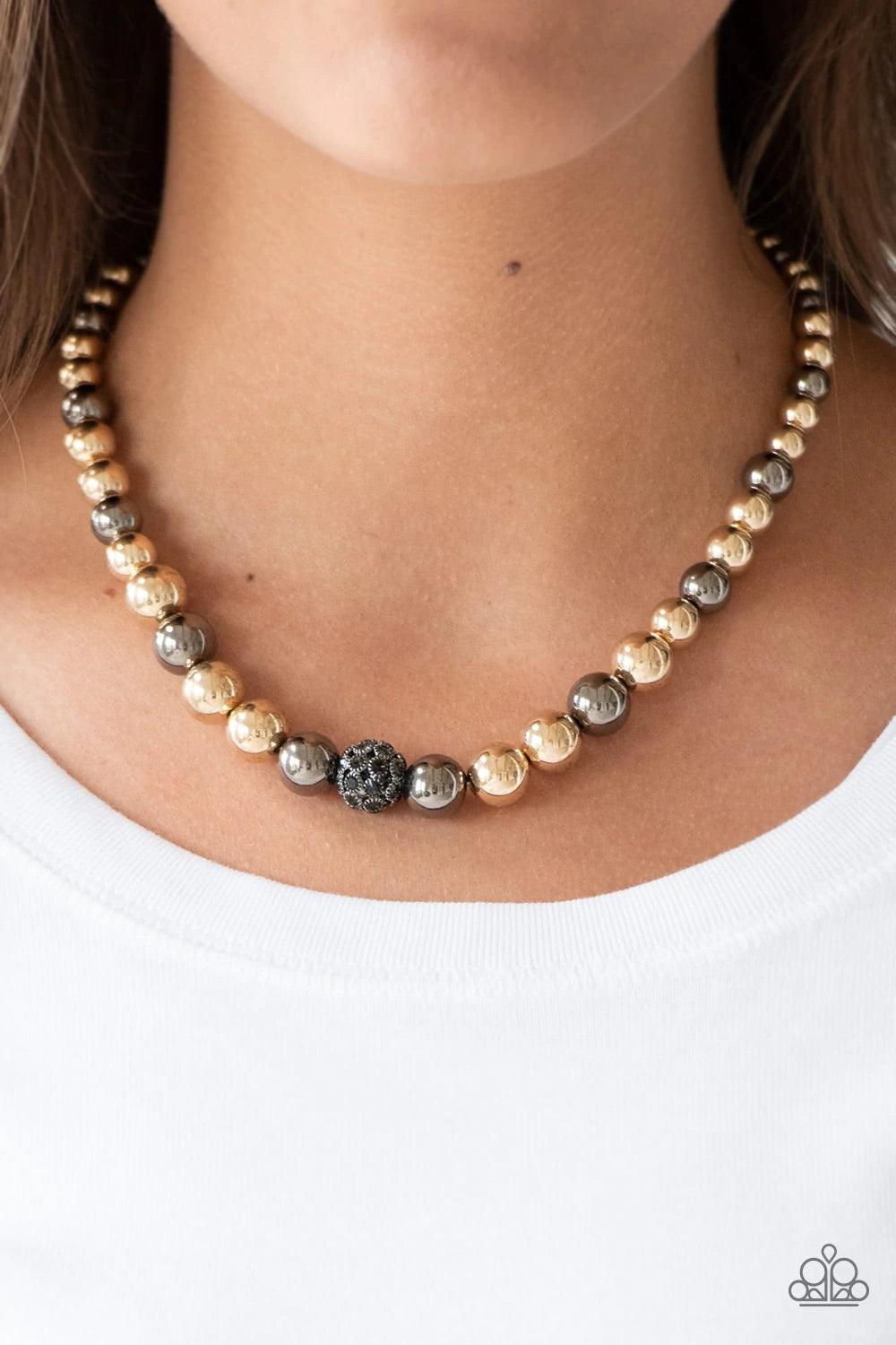 Paparazzi Accessories High Stakes FAME - Multi Gradually increasing in size near the center, glistening gold and gunmetal beads are threaded along an invisible wire below the collar. Encrusted in smoky rhinestones, a sparkling gunmetal bead adorns the cen