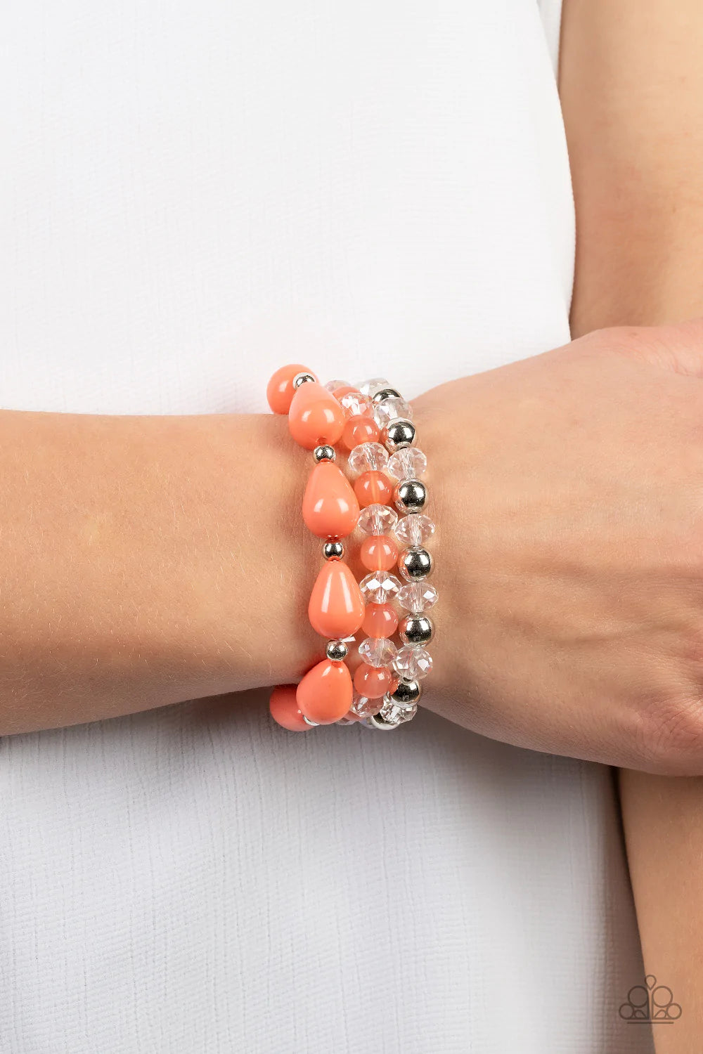 Paparazzi Accessories Beachside Brunch - Orange A whimsical assortment of crystal-like beads, silver beads, opaque coral beads, and coral teardrop beads are threaded along stretchy bands around the wrist, resulting in colorful layers. Sold as one set of t
