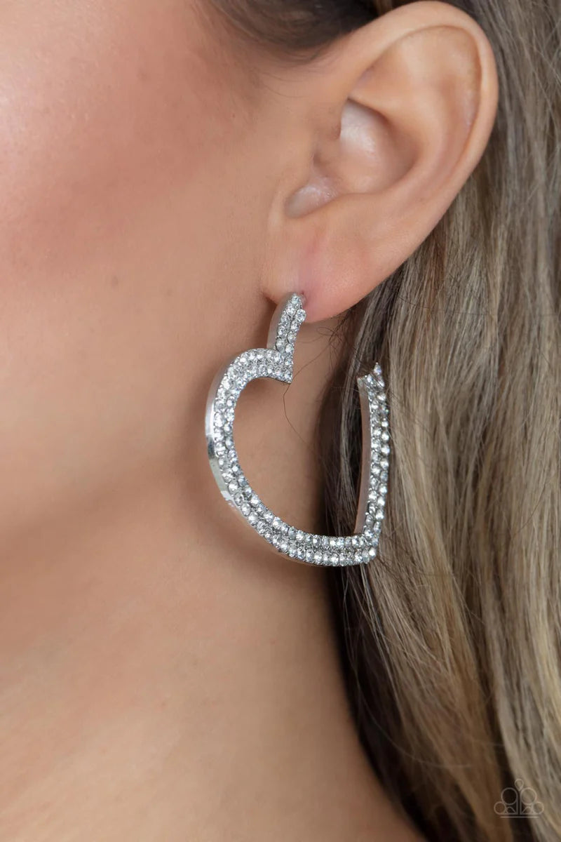 Paparazzi Accessories Amore To Love - White Two rows of blinding white rhinestones are encrusted along the front of a heart shaped silver hoop, creating a heart-stopping sparkle. Hoop measures approximately 2" in diameter. Earring attaches to a standard p