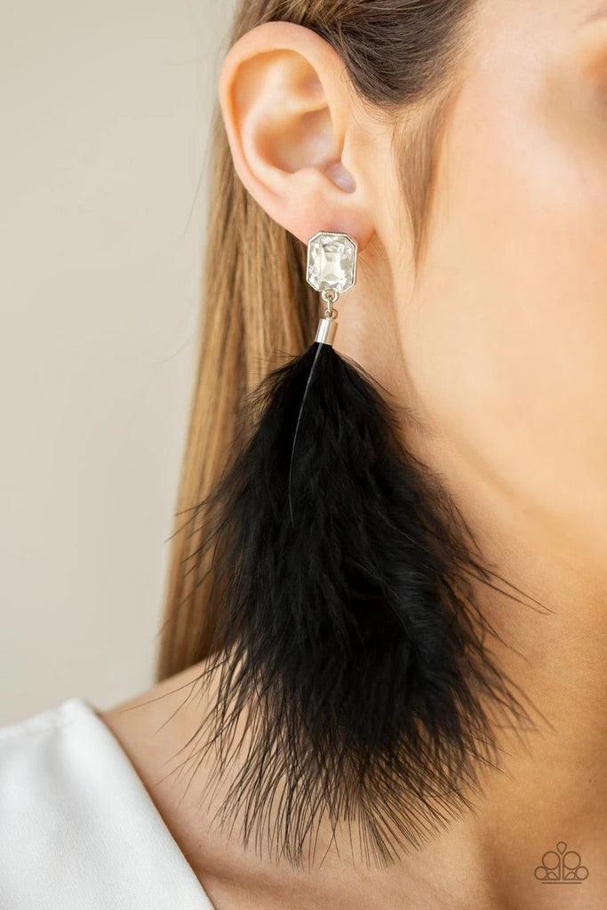 Paparazzi Accessories The SHOWGIRL Must Go On! - Black A soft black feather swings from the bottom of a regal emerald style cut white rhinestone, creating a fabulously glamorous fringe. Earring attaches to a standard post fitting. Sold as one pair of post