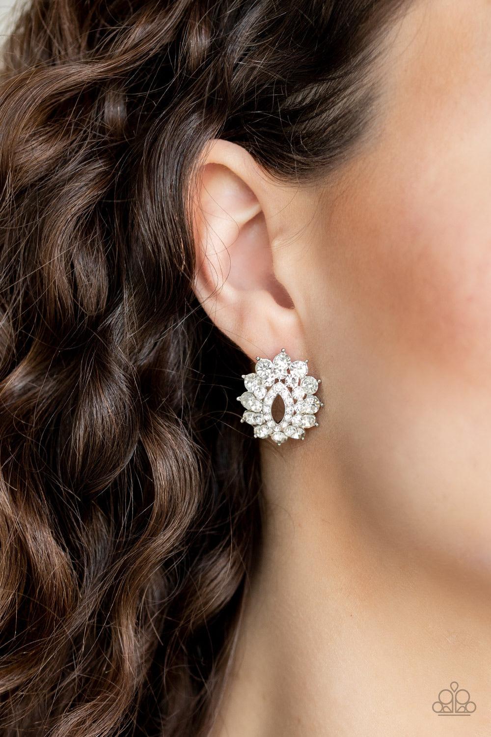 Paparazzi Accessories Brighten The Moment - White Varying in size, three stacks of glittery white rhinestones fan out from an airy center, coalescing into a stellar frame. Earring attaches to a standard post fitting. Jewelry
